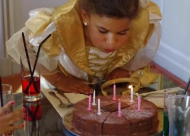 Children birthday cake blowing candels